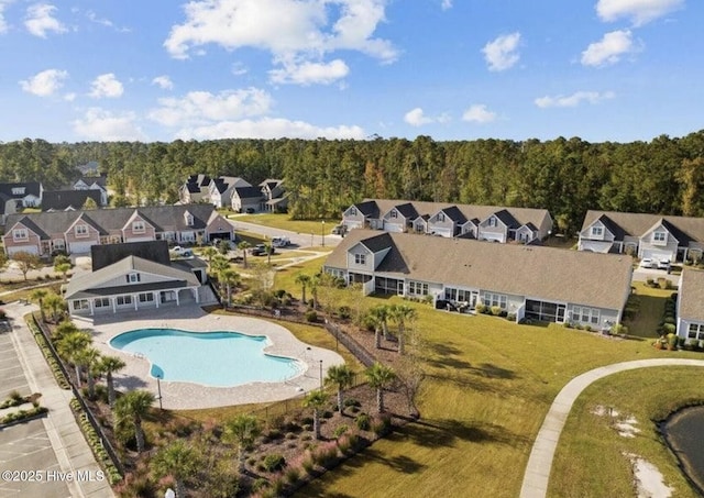 birds eye view of property featuring a forest view and a residential view