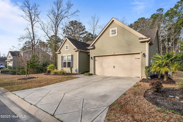 view of front of house featuring concrete driveway and a garage