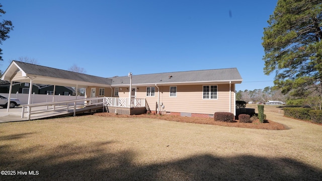 rear view of house with a wooden deck, a lawn, fence, and crawl space