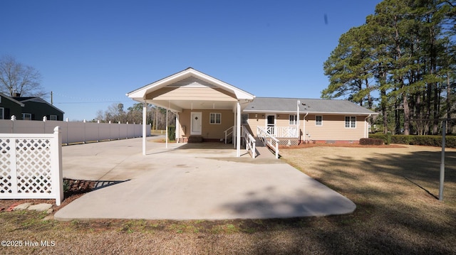 back of house featuring a carport, a yard, fence, and crawl space