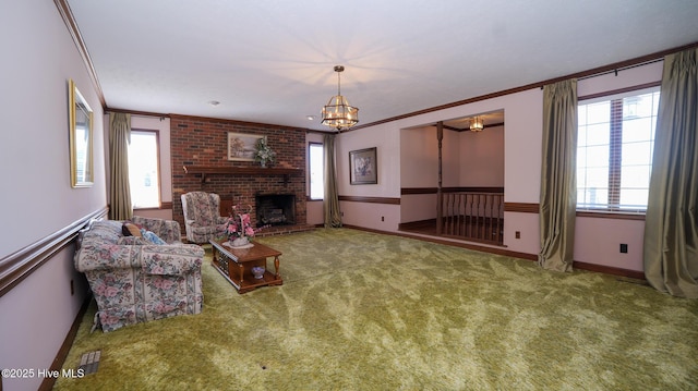 carpeted living area with a notable chandelier, a fireplace, baseboards, and ornamental molding