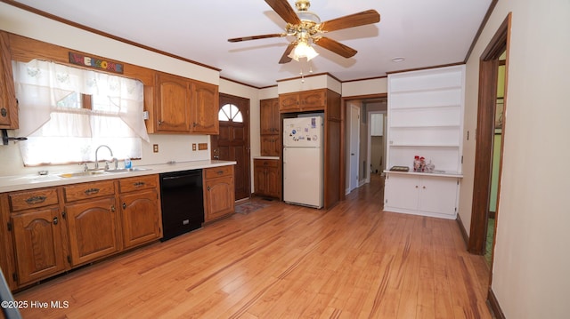 kitchen with light wood finished floors, dishwasher, brown cabinets, freestanding refrigerator, and a sink