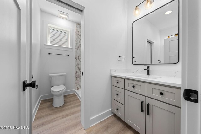 304 Alabama Ave Unit 2, Carolina Beach, NC 28428 - bathroom with wood finished floors, toilet, and baseboards