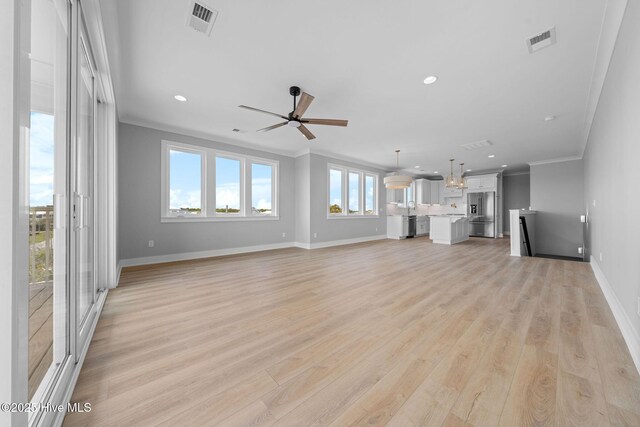 304 Alabama Ave Unit 2, Carolina Beach, NC 28428 - unfurnished living room featuring recessed lighting, light wood-type flooring, a ceiling fan, visible vents, and ornamental molding