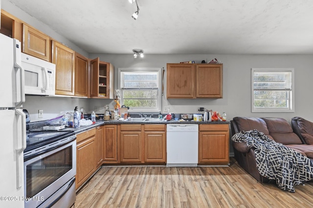 1525 Piney Green Rd, Jacksonville, NC 28546 - kitchen featuring white appliances, a healthy amount of sunlight, light wood-type flooring, and a sink