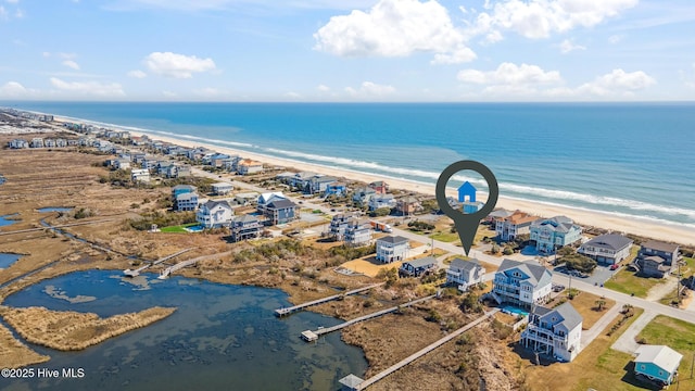 drone / aerial view featuring a view of the beach and a water view