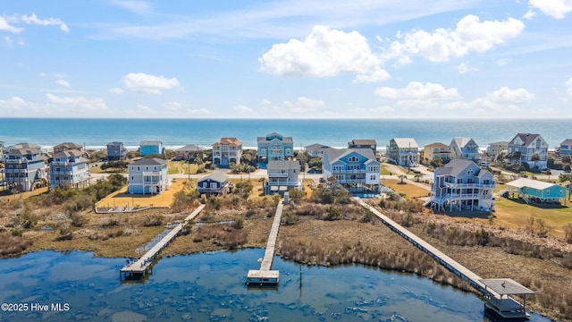 birds eye view of property with a water view and a residential view