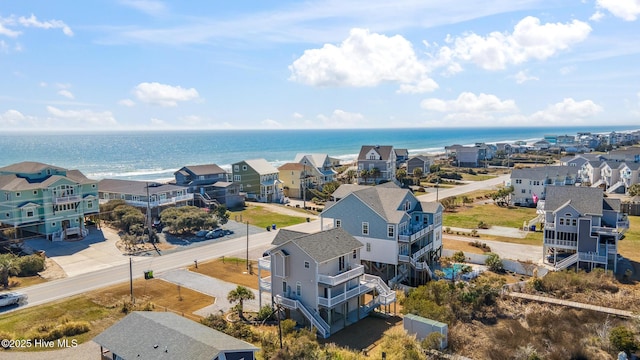 drone / aerial view featuring a residential view and a water view