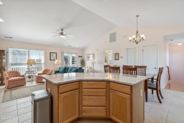 kitchen featuring light tile patterned floors, visible vents, and vaulted ceiling