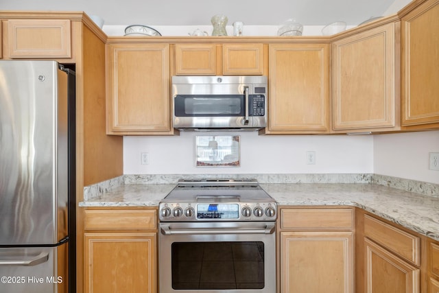 kitchen with stainless steel appliances and light brown cabinetry