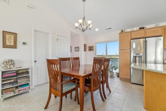 dining room featuring light tile patterned floors, visible vents, a chandelier, and vaulted ceiling