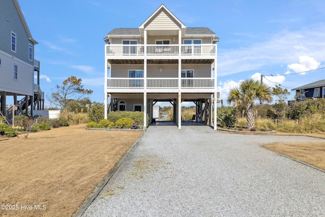 raised beach house with a carport and driveway