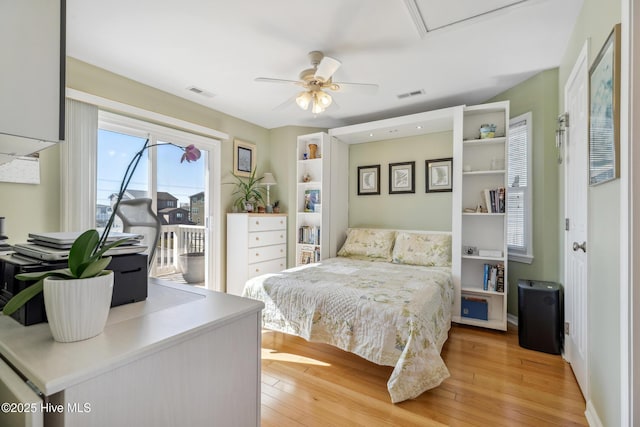 bedroom featuring visible vents, light wood-style floors, access to exterior, and a ceiling fan