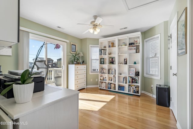 office space featuring visible vents, baseboards, and light wood-style floors