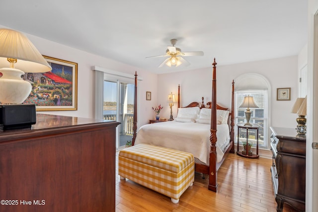 bedroom featuring light wood-style flooring, access to exterior, and a ceiling fan