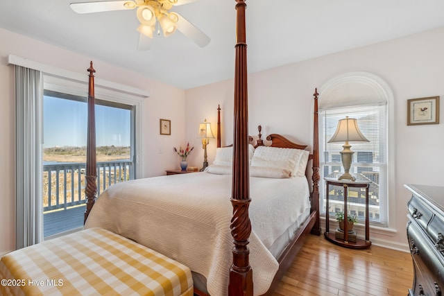 bedroom with access to exterior, a ceiling fan, and wood-type flooring