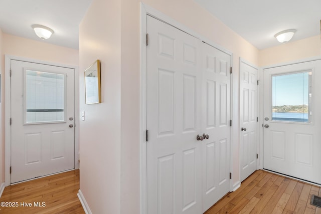 interior space featuring light wood finished floors, visible vents, and baseboards