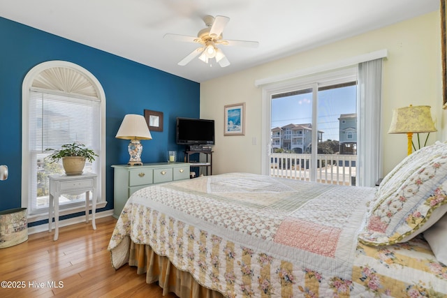 bedroom featuring access to exterior, light wood-style flooring, baseboards, and ceiling fan