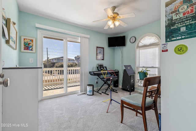 carpeted office with a ceiling fan, visible vents, a wealth of natural light, and baseboards