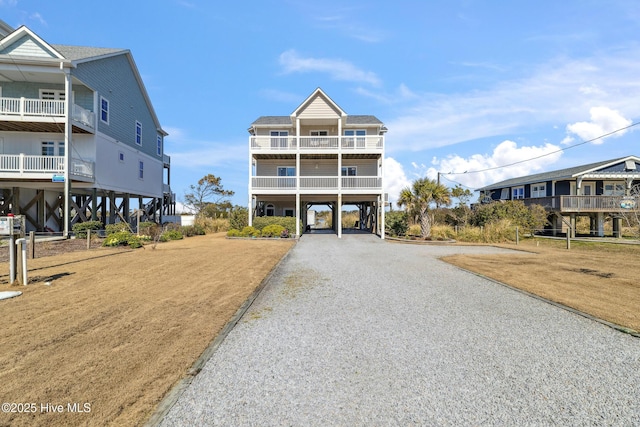 raised beach house with a carport and driveway