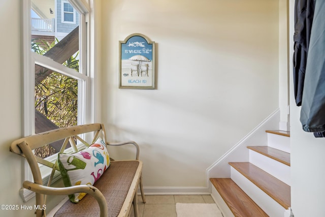 stairs featuring tile patterned floors and baseboards