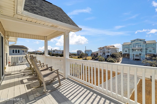 wooden terrace featuring a residential view