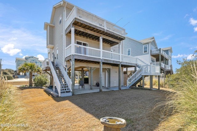 back of property featuring stairs and a patio