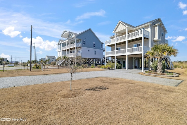 exterior space featuring a carport, driveway, and a balcony