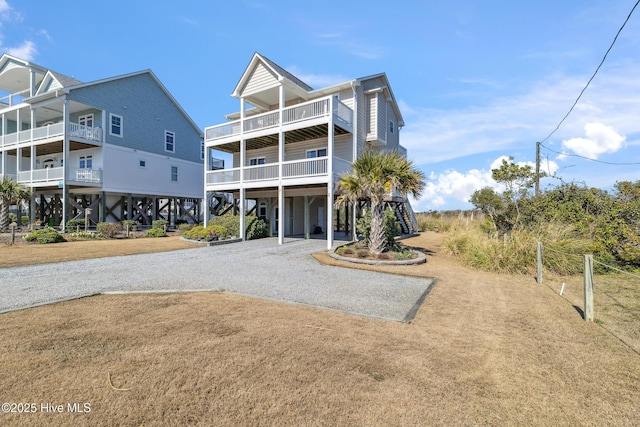 rear view of property with a carport and driveway