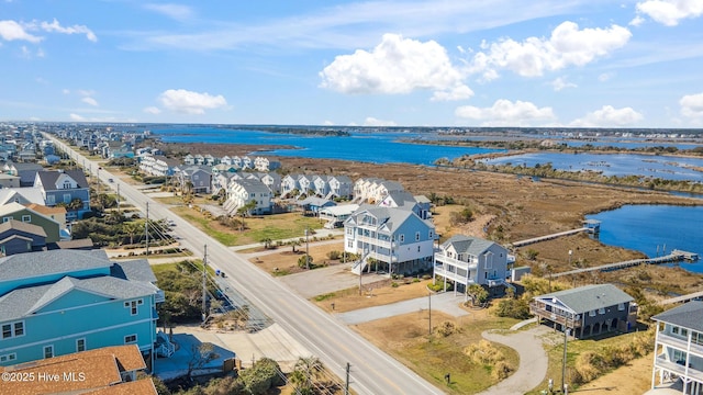 birds eye view of property featuring a water view and a residential view