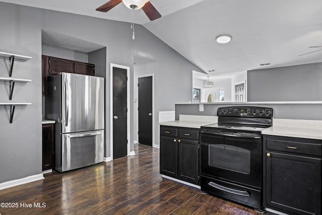 kitchen with black range with electric stovetop, freestanding refrigerator, light countertops, lofted ceiling, and dark wood-style flooring