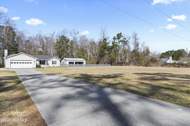 view of front of home with a garage, driveway, and a front yard