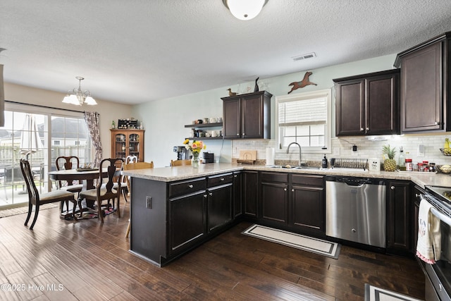 kitchen featuring a sink, visible vents, dark wood-type flooring, and appliances with stainless steel finishes