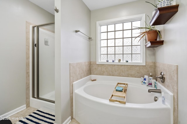 full bathroom featuring a bath, tile patterned floors, and a stall shower