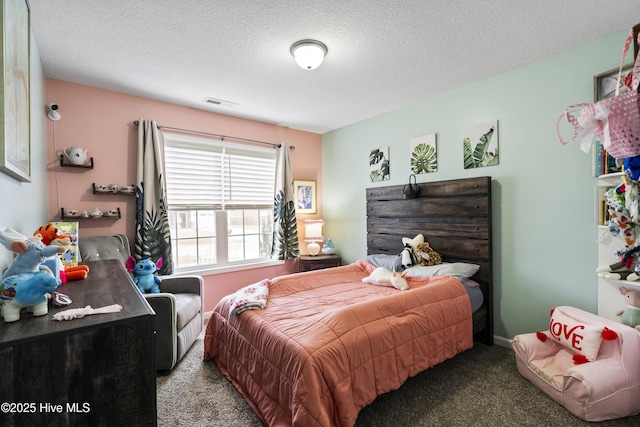 carpeted bedroom featuring visible vents and a textured ceiling