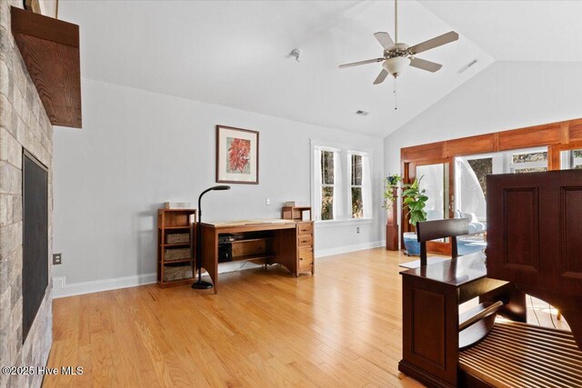 office space featuring high vaulted ceiling, light wood-style floors, visible vents, and ceiling fan