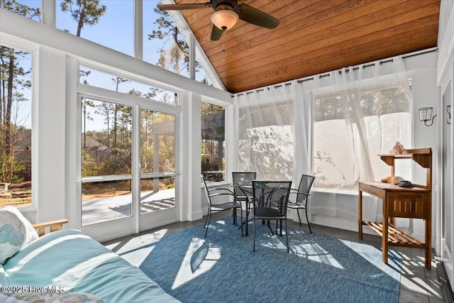 sunroom with lofted ceiling, wood ceiling, and a ceiling fan