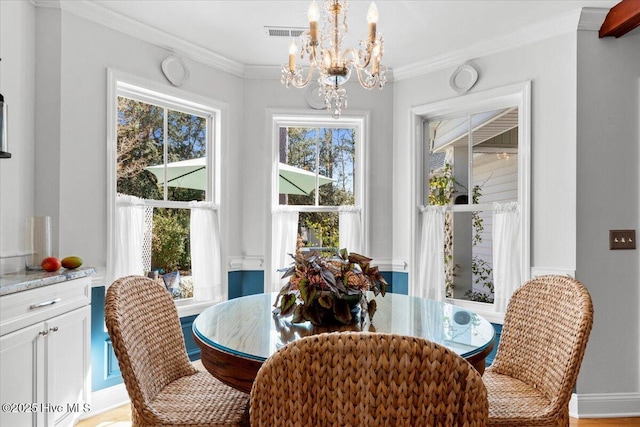 dining space with plenty of natural light, crown molding, and visible vents