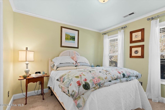 bedroom featuring visible vents, baseboards, ornamental molding, and carpet flooring