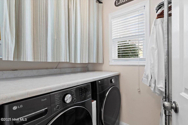 washroom featuring laundry area and washer and clothes dryer