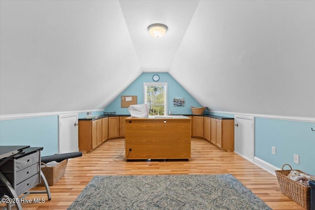 bonus room with light wood finished floors and lofted ceiling