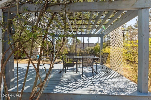 wooden deck with outdoor dining area and a pergola