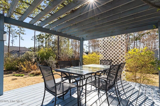 wooden terrace featuring outdoor dining area and a pergola