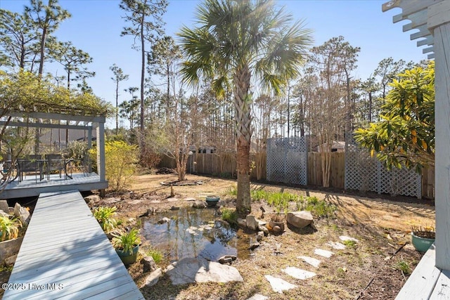 view of yard with a deck and fence