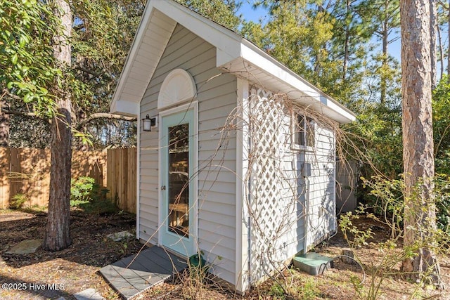 view of shed featuring fence