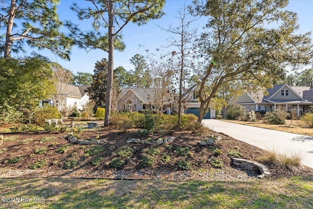 view of front of home with concrete driveway and a garage