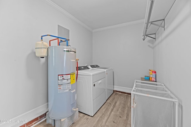 clothes washing area featuring electric water heater, crown molding, washing machine and dryer, laundry area, and light wood-style floors