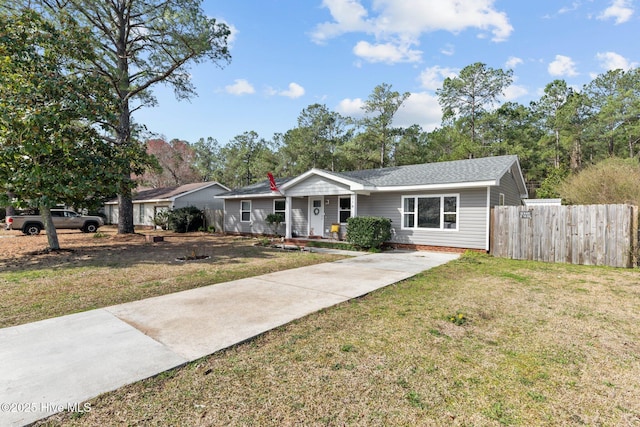 single story home with a front lawn, concrete driveway, and fence