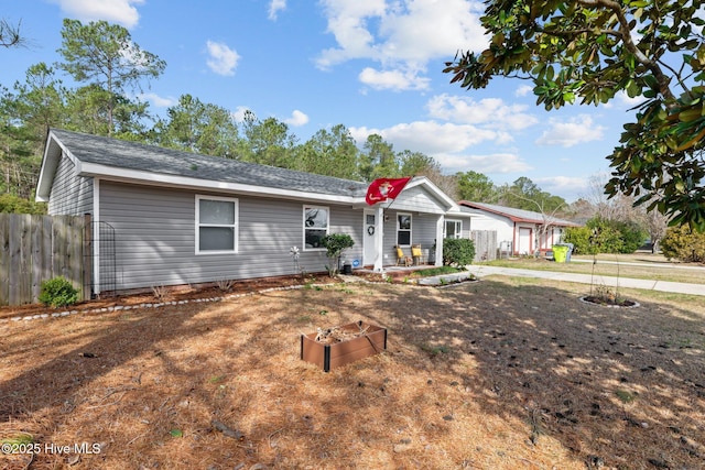 ranch-style home featuring fence