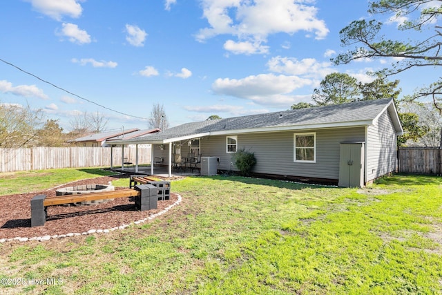 back of house with central AC unit, a lawn, a fenced backyard, a garden, and a patio